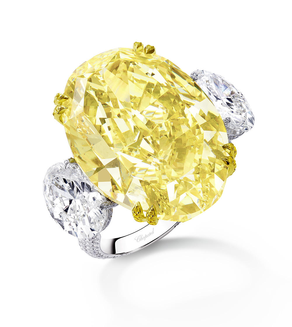 Ring in Fairmined-certified 18-carat white and yellow gold set with a 30.63-carat oval-cut fancy intense yellow diamond set with two 2-carat oval-cut diamonds on either side, on a band entirely set with brilliant-cut diamonds and prongs set with brilliant-cut yellow diamonds 30.63-carat oval-cut fancy intense yellow diamond