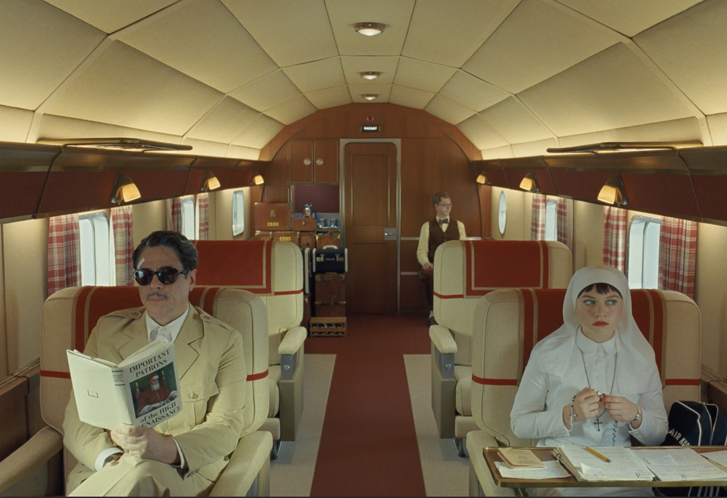 Benicio Del Toro, Mia Threapleton, and Michael Cera Benicio Del Toro, Mia Threapleton, and Michael Cera, in the Phoenician Scheme by Wes Anderson, text by Alexandra Ivancenco Mas