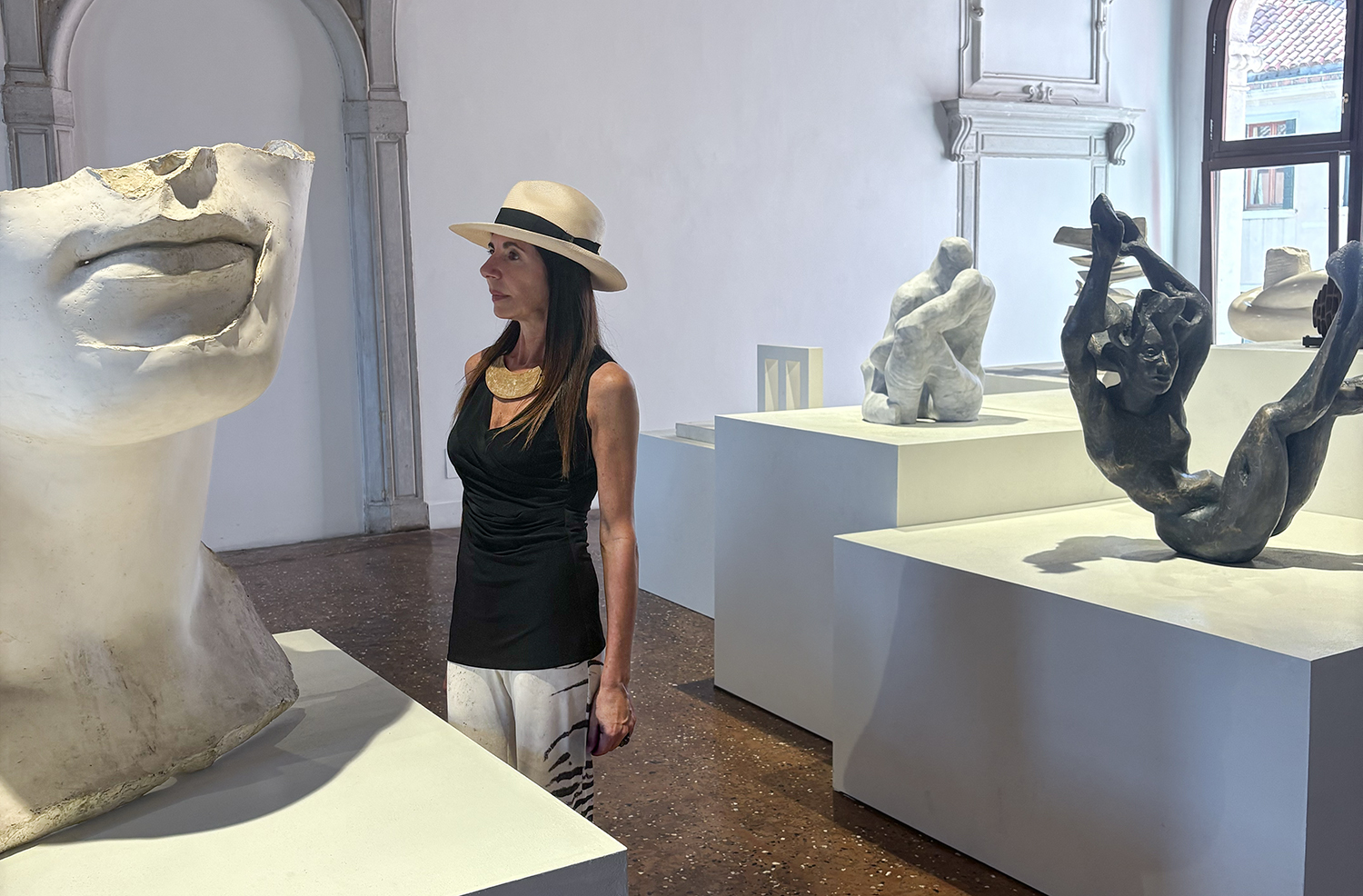 curator Roberta Semeraro looking at HORIZON, 1984, Igor Mitoraj fiberglass model, 104×107×75 cm, the EDGE mag 